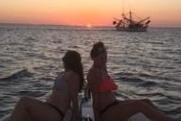 a man standing next to a body of water