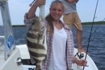 a person holding a fish on a boat