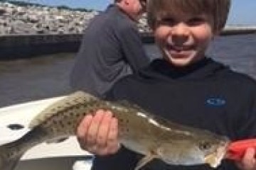 a man holding a fish