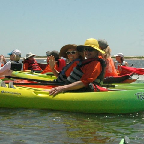 a group of people riding on the back of a boat