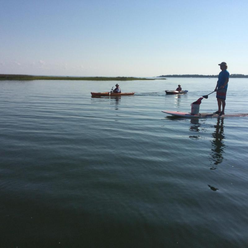 a group of people in a boat on a body of water