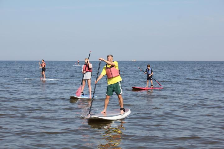a couple of people that are standing in the water