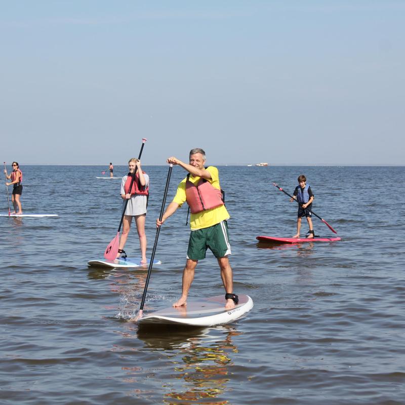 a couple of people that are standing in the water