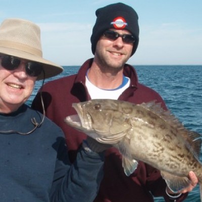 a person holding a fish in the water