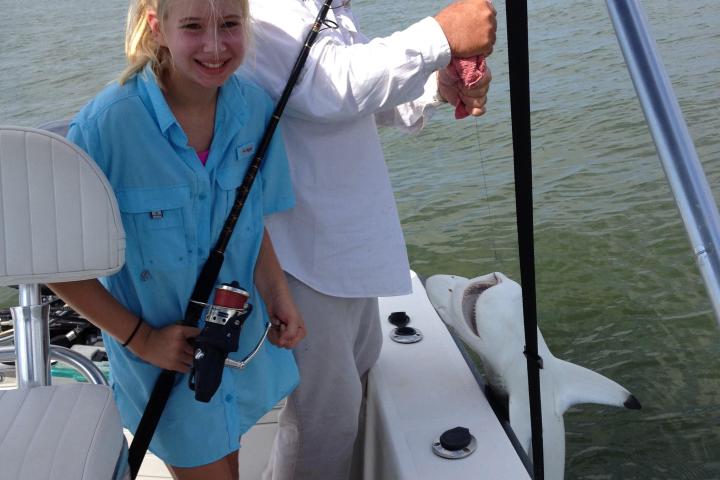 a person standing next to a body of water