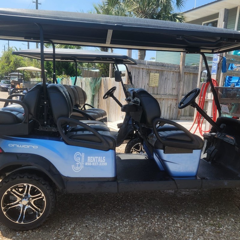a motorcycle parked in front of a blue car